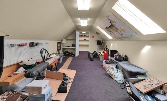 interior space featuring lofted ceiling with skylight and carpet