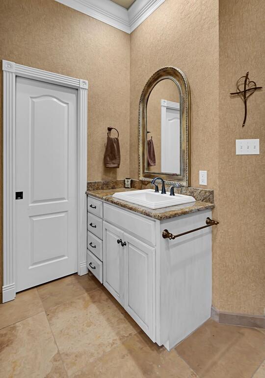 bathroom featuring vanity and ornamental molding