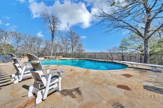 view of swimming pool with a fenced backyard, a pool with connected hot tub, a patio, and a diving board