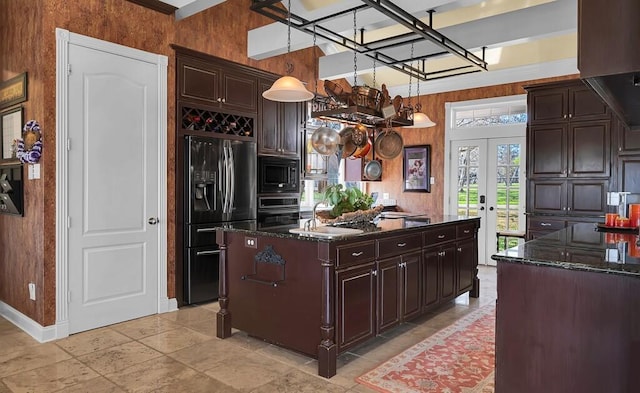 kitchen with oven, a sink, french doors, built in microwave, and black refrigerator with ice dispenser