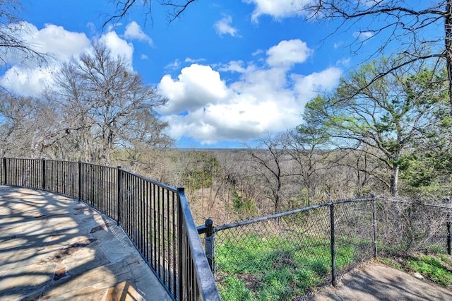 view of yard with fence and a view of trees