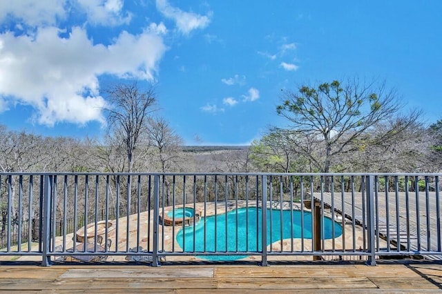 view of swimming pool with a pool with connected hot tub