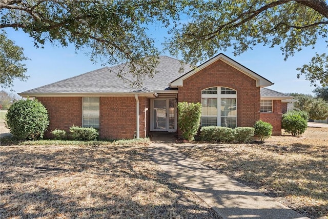 ranch-style house with brick siding and roof with shingles