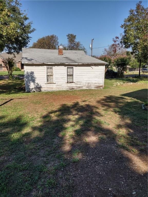 view of property exterior with a lawn