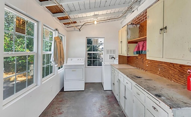 clothes washing area with wood ceiling, cabinets, and independent washer and dryer