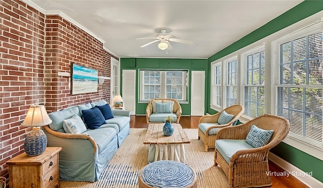 sunroom / solarium featuring ceiling fan and plenty of natural light