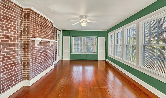 unfurnished sunroom featuring plenty of natural light and ceiling fan