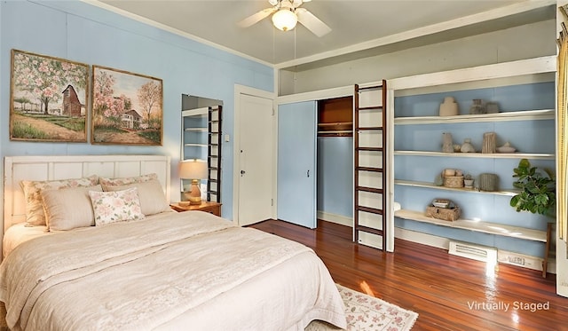 bedroom with ceiling fan, ornamental molding, dark wood-type flooring, and a closet