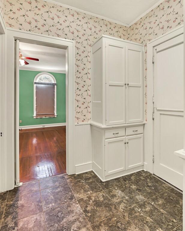 hallway featuring dark hardwood / wood-style floors and crown molding