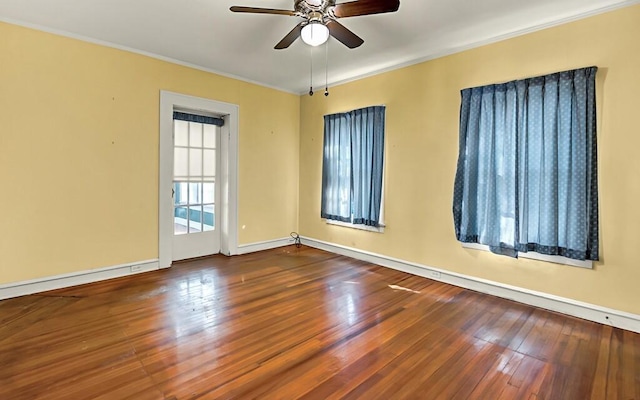 spare room featuring hardwood / wood-style floors, ceiling fan, and crown molding