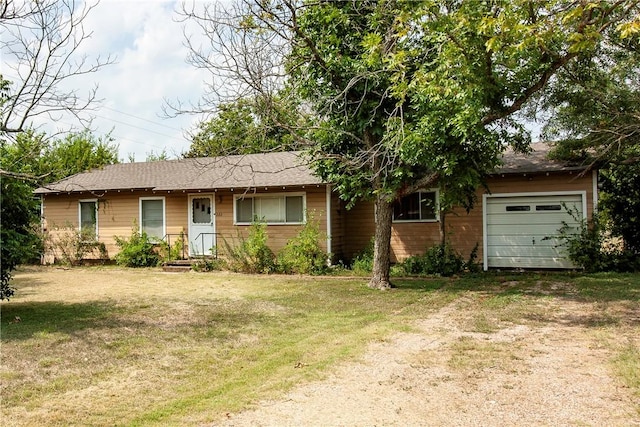 ranch-style home featuring a garage and a front yard