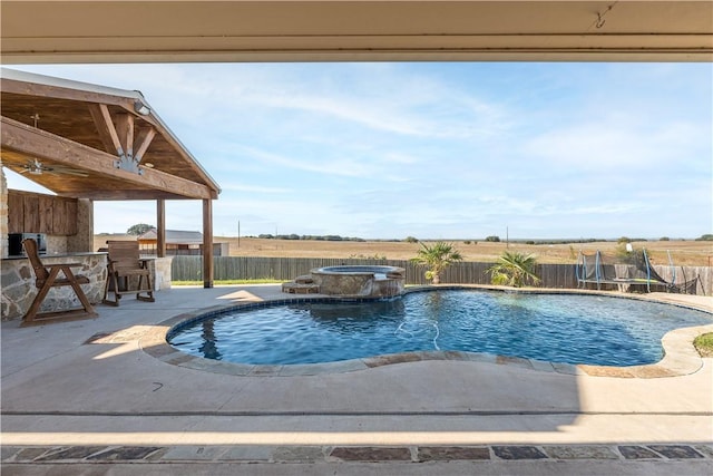 view of pool featuring an in ground hot tub, a patio, and an outdoor bar