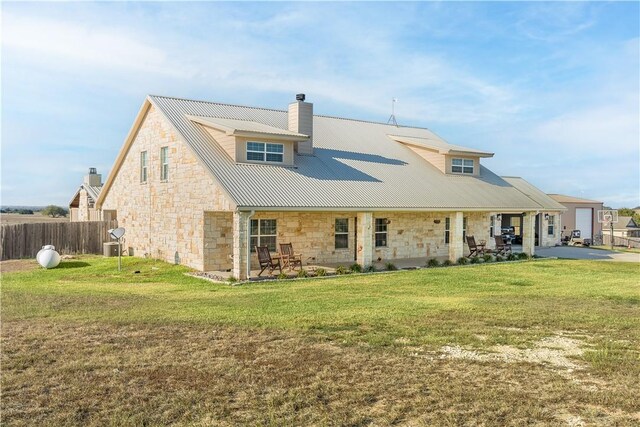 rear view of house with a patio area and a yard