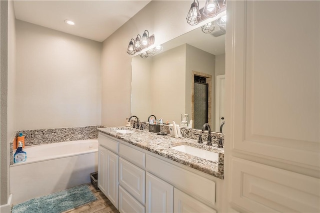 bathroom with vanity, separate shower and tub, and wood-type flooring