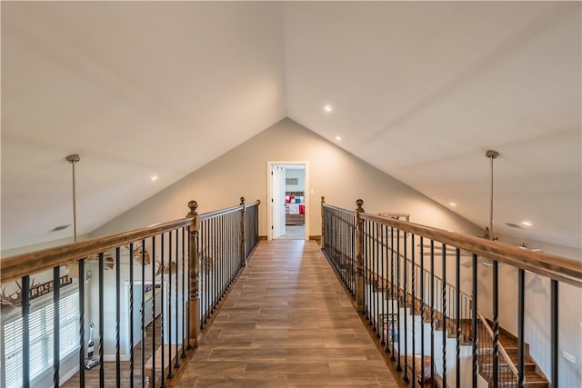 hall featuring wood-type flooring and lofted ceiling