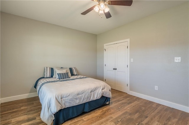 bedroom featuring a closet, ceiling fan, and dark hardwood / wood-style flooring