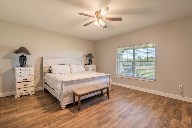 bedroom with ceiling fan and dark hardwood / wood-style floors