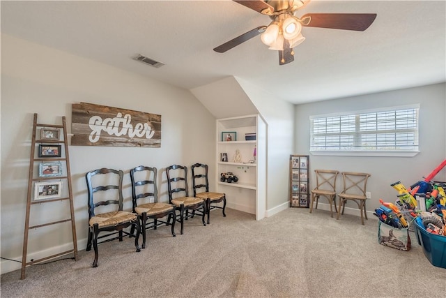 living area featuring carpet flooring and ceiling fan