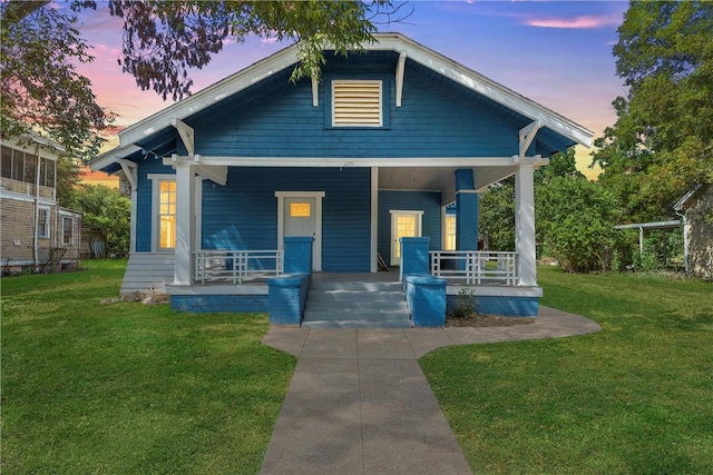 bungalow-style home featuring a lawn and a porch