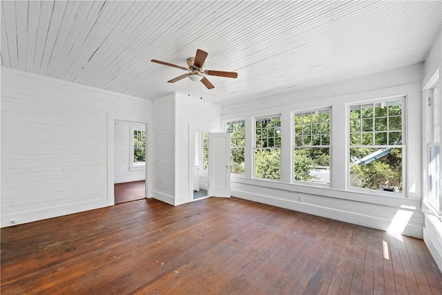 unfurnished sunroom with ceiling fan