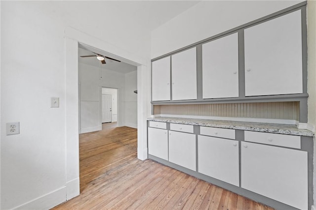 kitchen featuring ceiling fan and light wood-type flooring