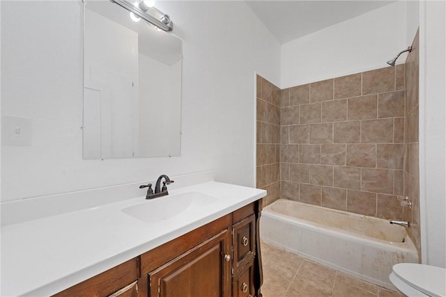 full bathroom featuring toilet, vanity, tile patterned floors, and tiled shower / bath combo