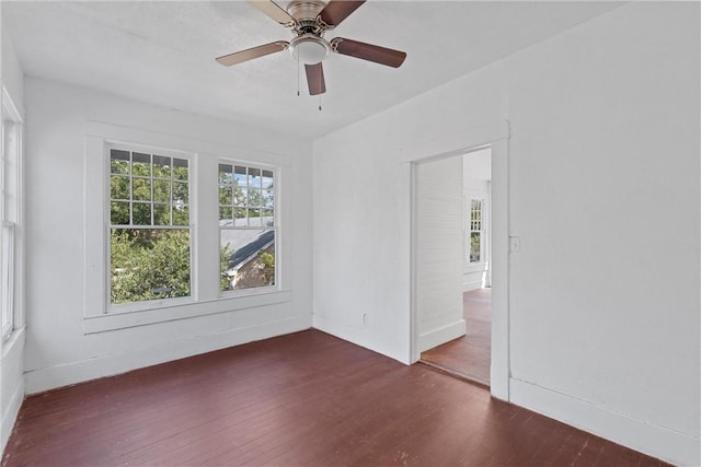 unfurnished room featuring dark hardwood / wood-style floors and ceiling fan