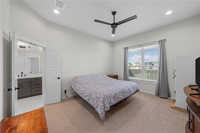 bedroom featuring recessed lighting, visible vents, a sink, and light carpet