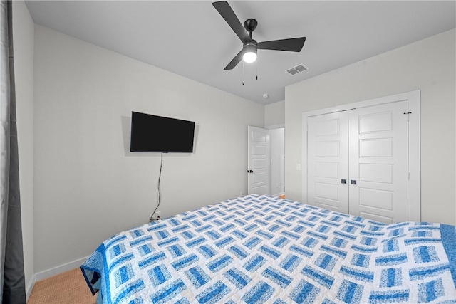 bedroom with carpet, a closet, visible vents, ceiling fan, and baseboards