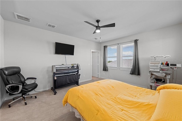 bedroom featuring baseboards, visible vents, a ceiling fan, and light colored carpet