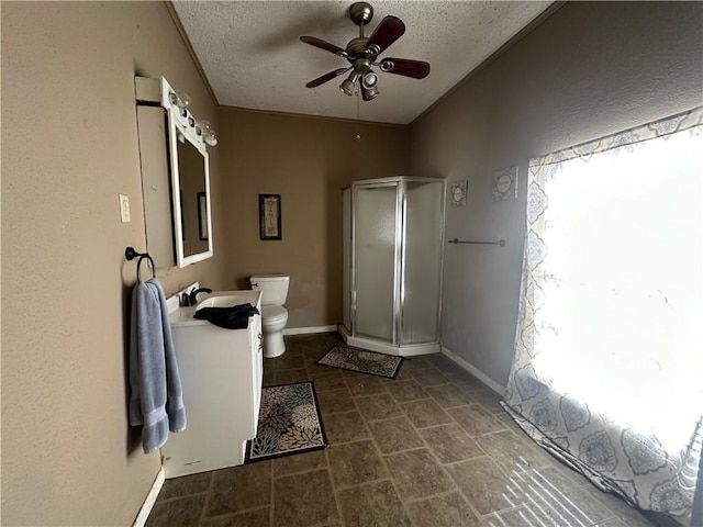 bathroom with ceiling fan, vanity, a textured ceiling, and toilet