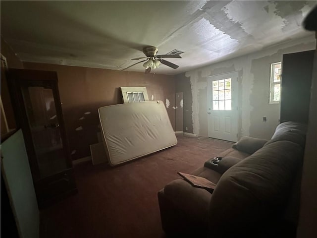 living room with dark carpet and ceiling fan