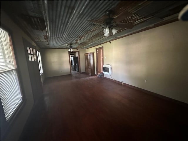 empty room featuring dark hardwood / wood-style flooring and heating unit