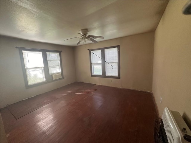 empty room with ceiling fan and dark hardwood / wood-style floors