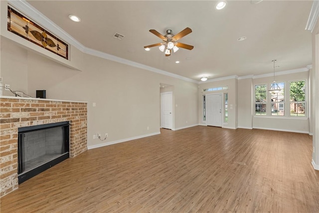 unfurnished living room featuring a brick fireplace, ceiling fan, wood-type flooring, and ornamental molding