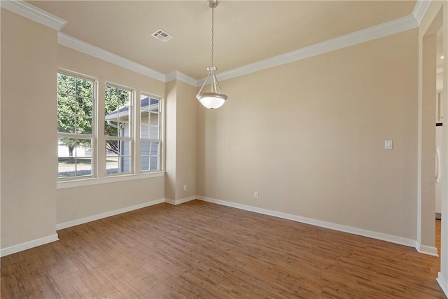 empty room with hardwood / wood-style flooring and crown molding