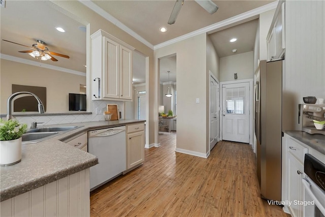 kitchen featuring sink, white cabinets, light hardwood / wood-style floors, and white appliances