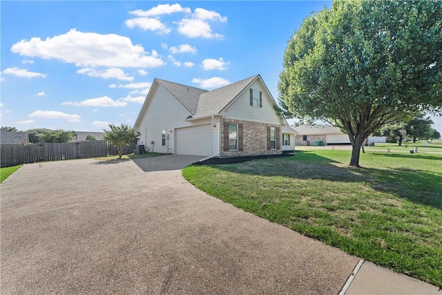 view of side of property with a yard and a garage