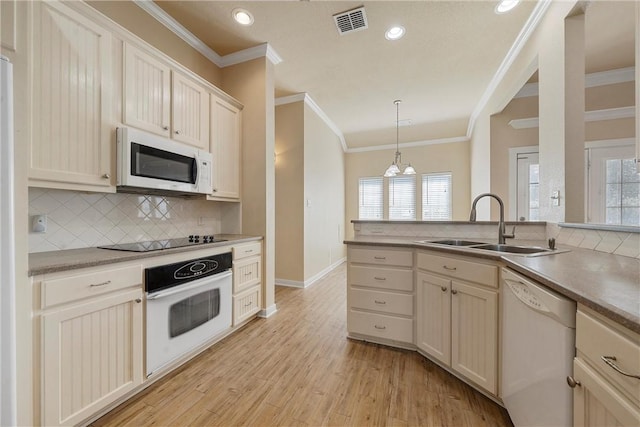 kitchen with white appliances, sink, light hardwood / wood-style flooring, ornamental molding, and decorative light fixtures