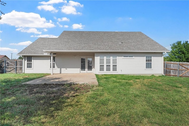 back of property with a patio area and a yard