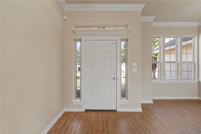 entryway with light wood-type flooring and ornamental molding