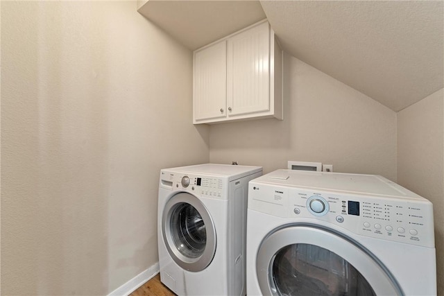 washroom with light hardwood / wood-style floors, cabinets, and independent washer and dryer