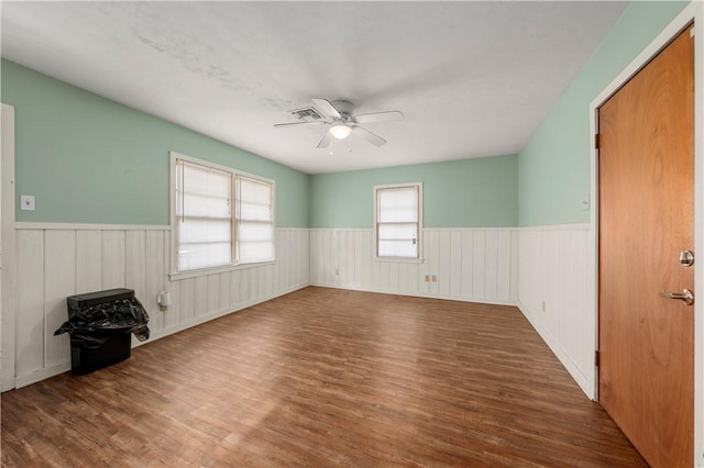 empty room featuring ceiling fan and dark hardwood / wood-style floors