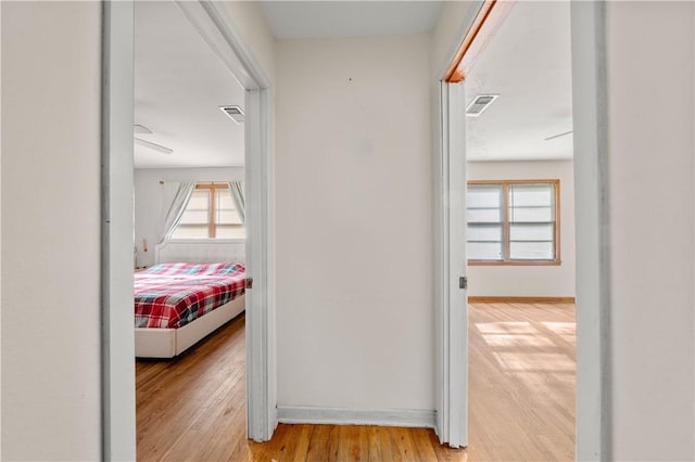 corridor with light hardwood / wood-style flooring