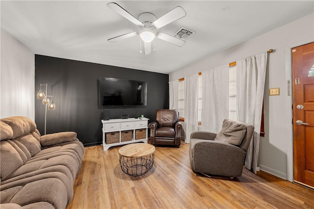 living room with ceiling fan and light hardwood / wood-style floors