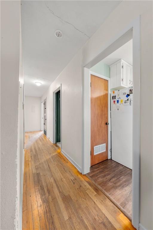 hall with light hardwood / wood-style flooring