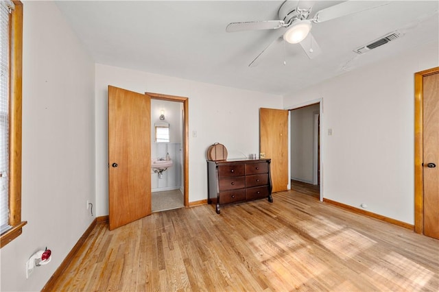 bedroom with ceiling fan, ensuite bathroom, and light hardwood / wood-style flooring