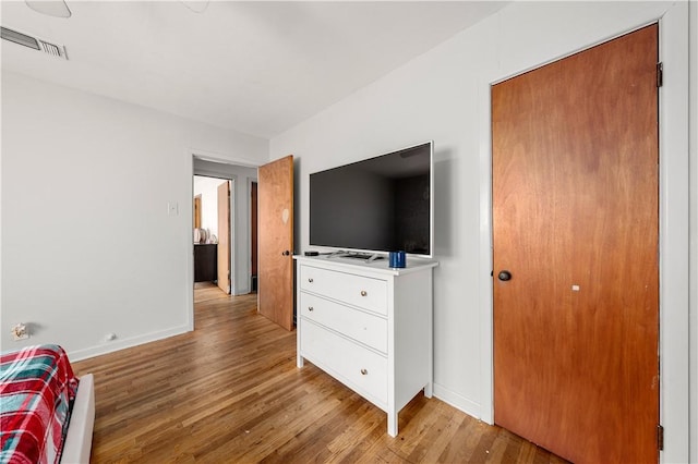 bedroom with a closet and light hardwood / wood-style floors