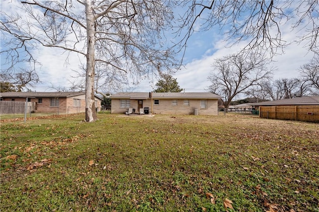 back of property featuring a lawn