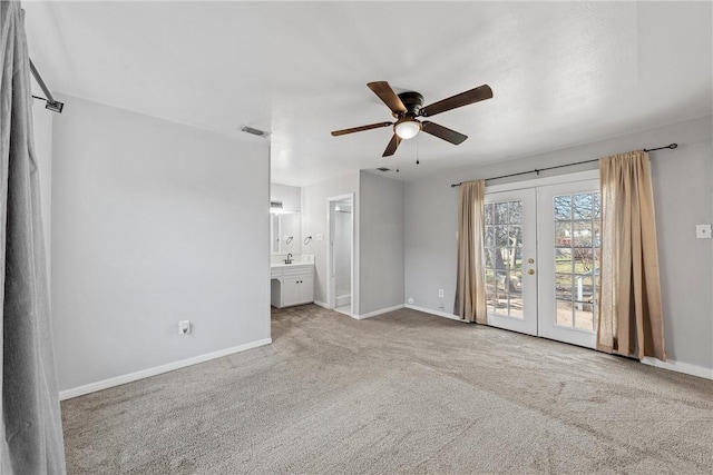 interior space with sink, ceiling fan, french doors, and carpet